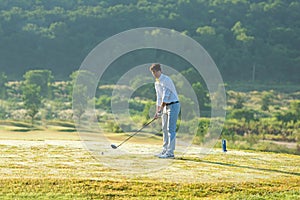 Golfer sport course golf ball fairway.ÃÂ  People lifestyle man playing game golf tee off on the green grass.